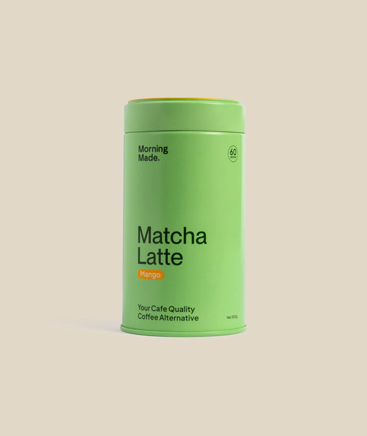 Green canister of 'Mango Matcha Latte' on a beige background